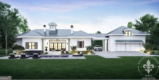 rear view of property featuring an attached garage, a standing seam roof, a yard, and metal roof