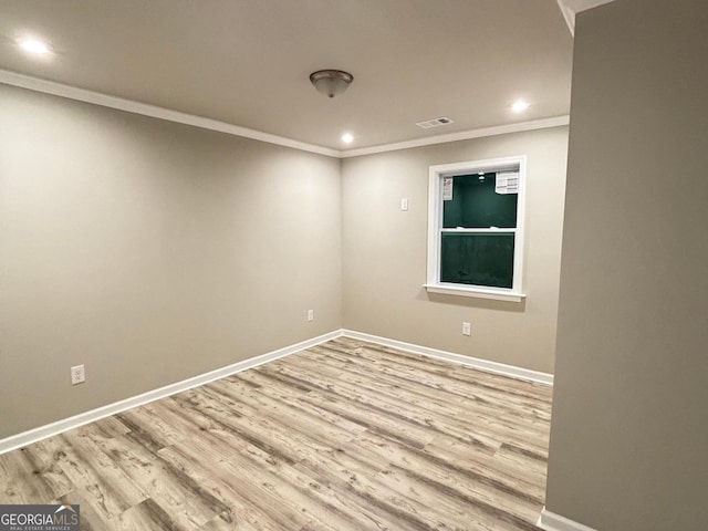 unfurnished room featuring light wood-type flooring and ornamental molding