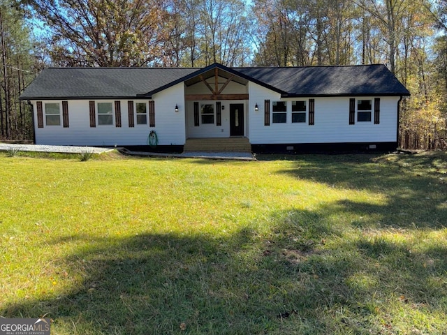 view of front facade featuring a front lawn and a storage unit