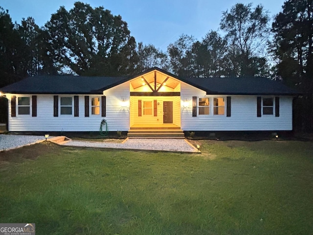 ranch-style home with a yard