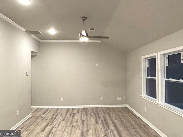 spare room with ceiling fan, hardwood / wood-style floors, crown molding, and lofted ceiling