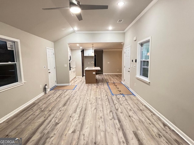 interior space with hardwood / wood-style floors, lofted ceiling, ceiling fan, and ornamental molding