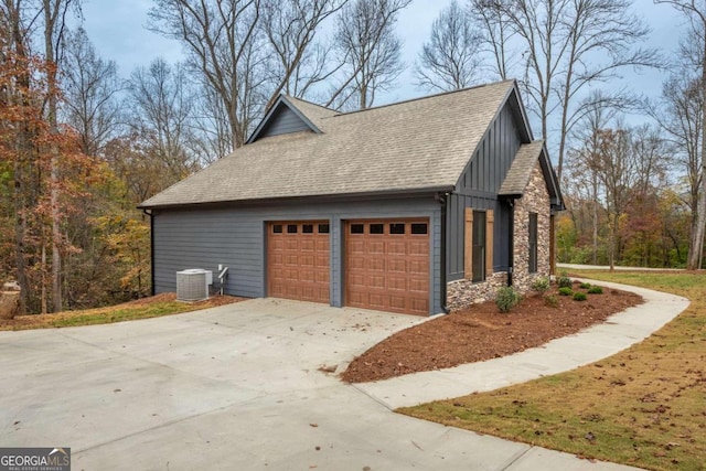 view of side of property with central AC and a garage