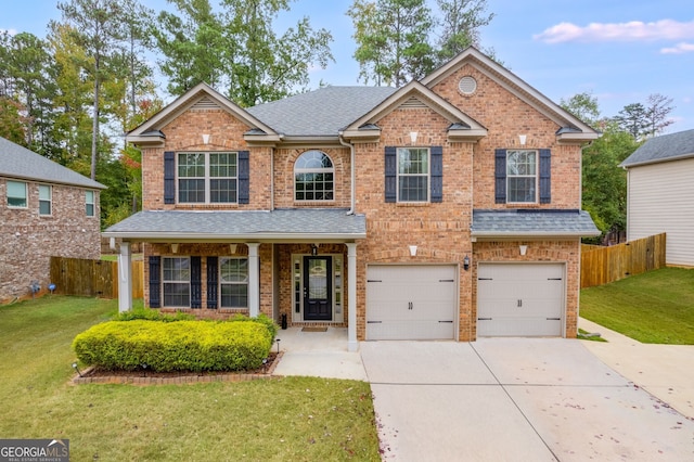 view of front of home featuring a front yard and a garage