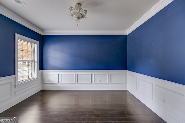 unfurnished room with crown molding, dark hardwood / wood-style floors, and a notable chandelier