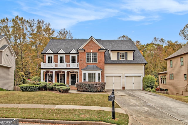 view of front of house with a balcony, a garage, and a front lawn