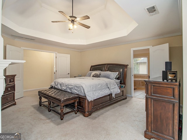 carpeted bedroom with a raised ceiling, ceiling fan, and ornamental molding