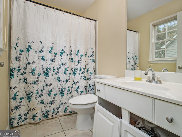 bathroom with tile patterned flooring, vanity, and toilet