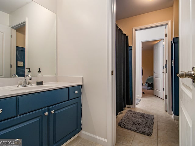 bathroom with tile patterned flooring and vanity