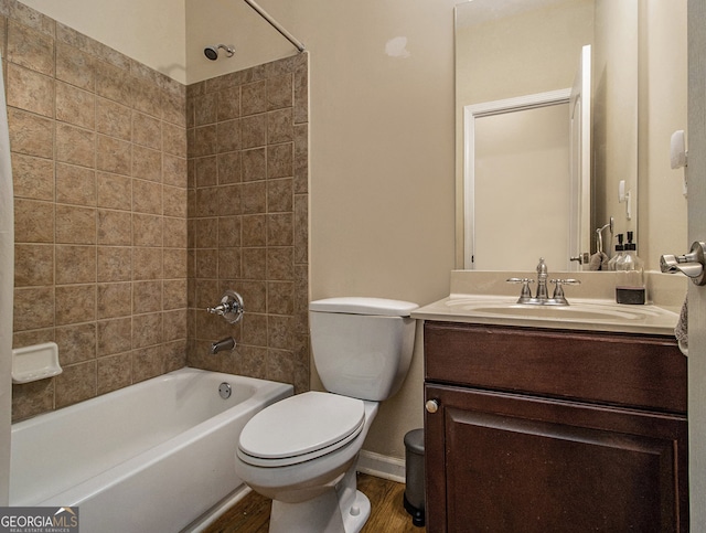 full bathroom featuring hardwood / wood-style floors, vanity, toilet, and tiled shower / bath