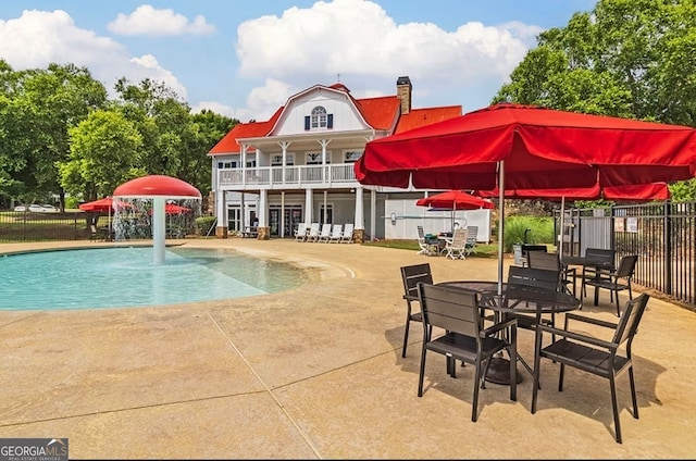 view of swimming pool with a patio