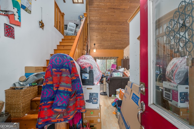 interior space with vaulted ceiling, wooden ceiling, and light hardwood / wood-style flooring