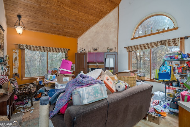 living room featuring plenty of natural light, wood ceiling, and high vaulted ceiling