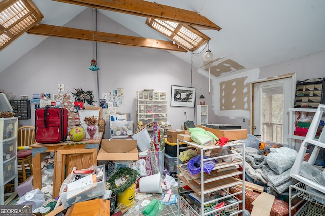 miscellaneous room featuring vaulted ceiling with beams