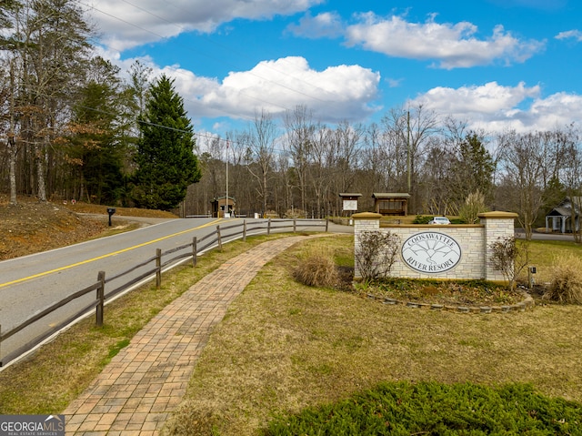 community / neighborhood sign with a lawn