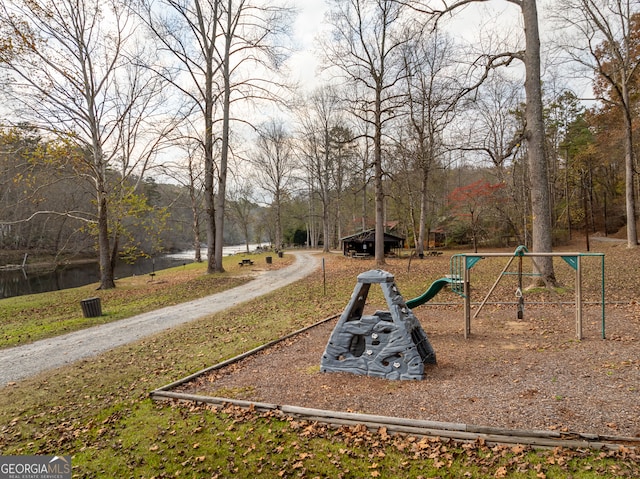 view of community featuring a playground and a water view