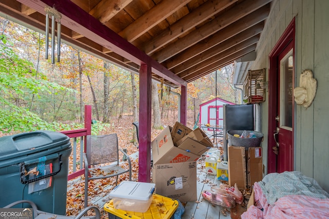 view of patio with area for grilling and a storage shed