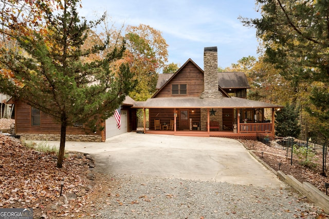 log cabin with a porch and a garage