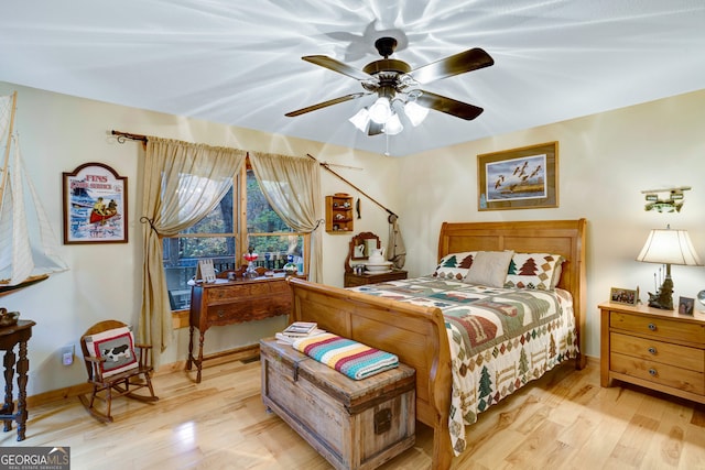 bedroom with light hardwood / wood-style floors and ceiling fan