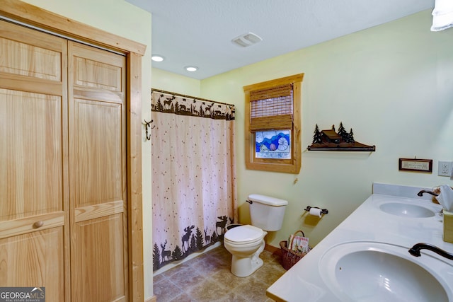 bathroom with a shower with curtain, vanity, and toilet