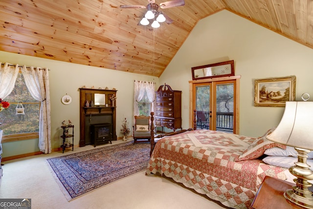 bedroom featuring ceiling fan, wood ceiling, multiple windows, and a wood stove