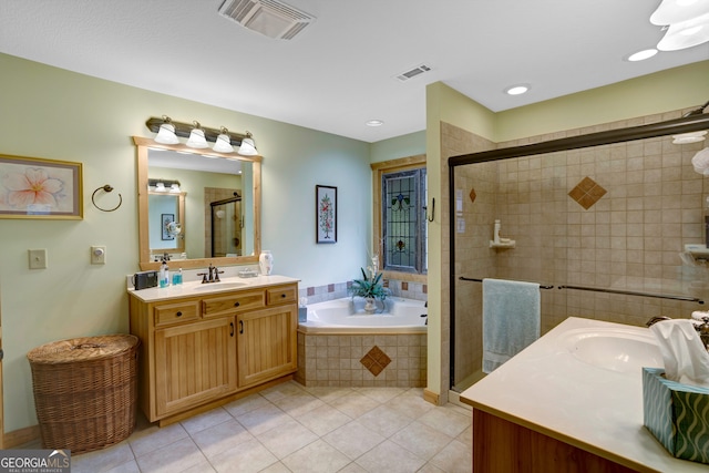 bathroom featuring vanity, tile patterned flooring, and plus walk in shower