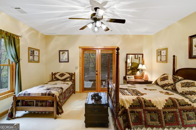 bedroom with ceiling fan, light colored carpet, access to outside, and french doors