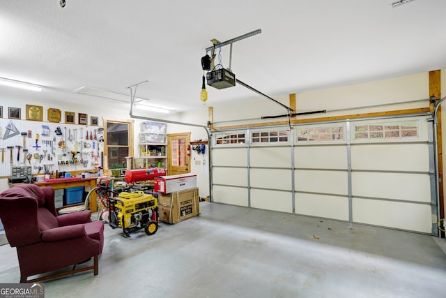 garage with a workshop area and a garage door opener