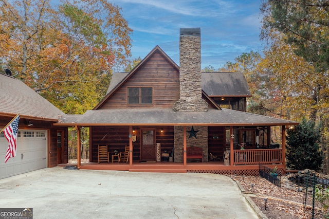 view of front of property featuring covered porch and a garage