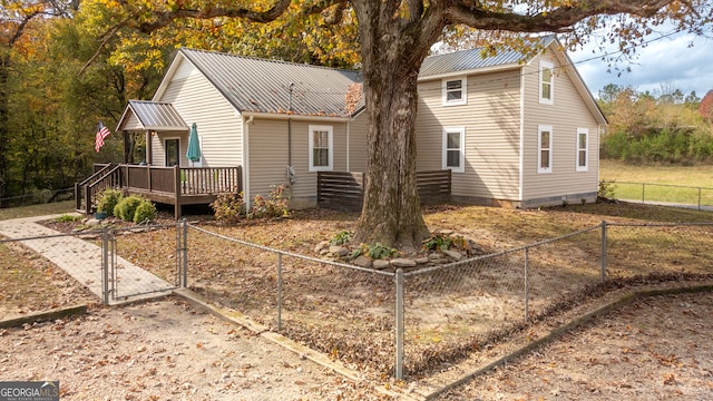 rear view of property featuring a wooden deck