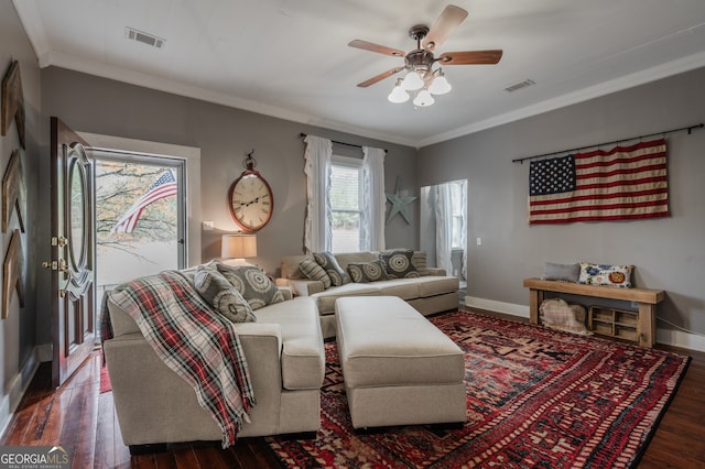 living room with ornamental molding, dark hardwood / wood-style floors, and ceiling fan