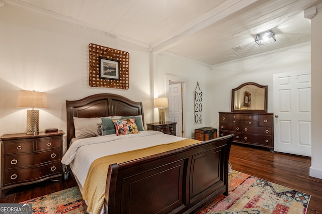 bedroom featuring dark wood-type flooring, beam ceiling, and ornamental molding