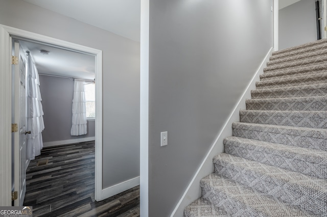 stairway with hardwood / wood-style flooring