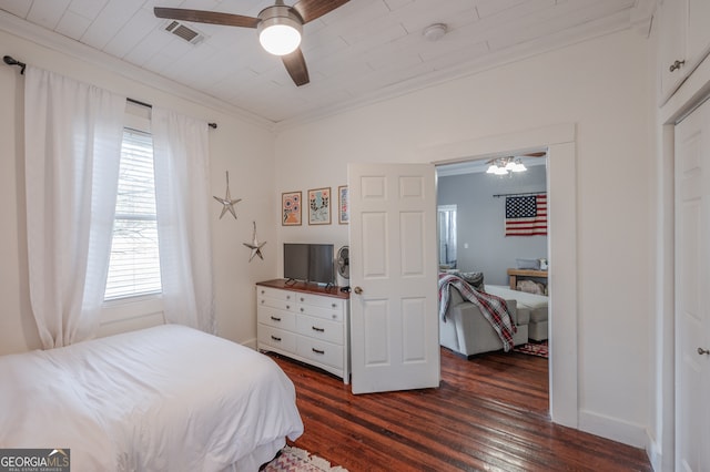 bedroom with dark hardwood / wood-style flooring, crown molding, and ceiling fan