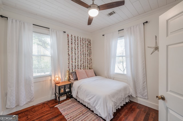 bedroom with multiple windows, dark wood-type flooring, and ceiling fan