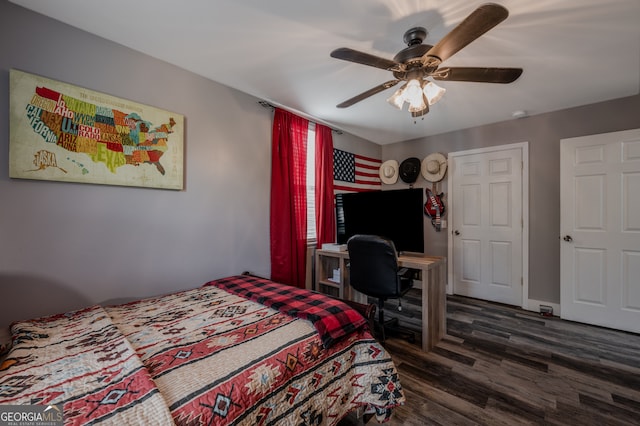 bedroom with dark hardwood / wood-style floors and ceiling fan