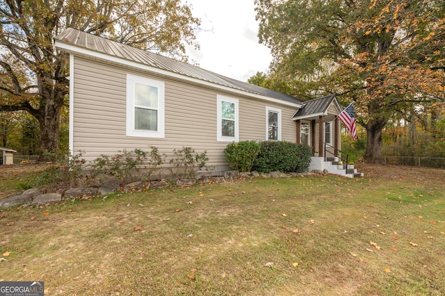 view of side of property with a yard