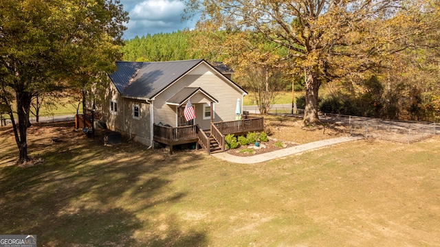 view of front facade featuring a deck and a front lawn