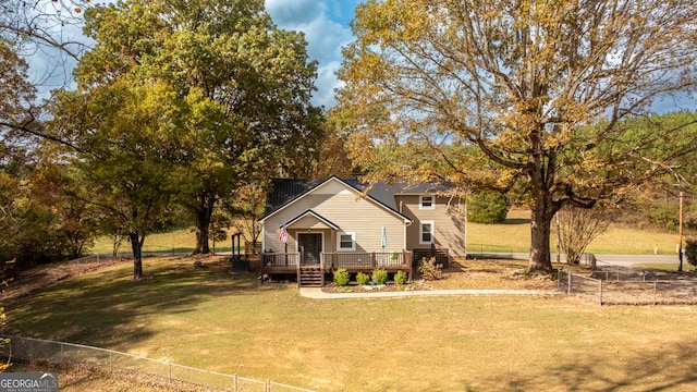 view of front of house featuring a front lawn and a deck