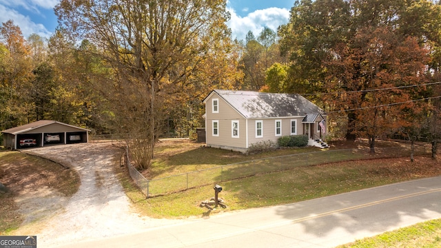 view of front of property with an outdoor structure, a garage, a front lawn, and a carport