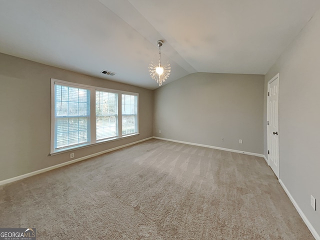 unfurnished room featuring light carpet, vaulted ceiling, and an inviting chandelier