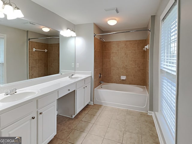 bathroom with vanity, tiled shower / bath combo, and tile patterned floors