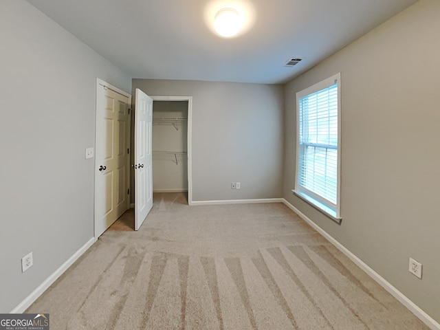 unfurnished bedroom with light colored carpet