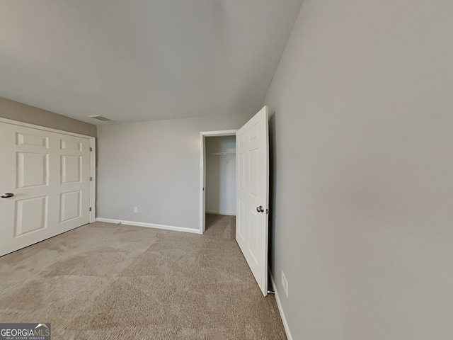 unfurnished bedroom with light carpet