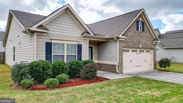 view of front of property featuring a front yard and a garage