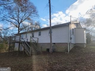 rear view of house featuring a deck