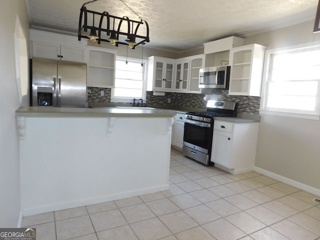 kitchen featuring stainless steel appliances, a sink, white cabinets, decorative backsplash, and open shelves