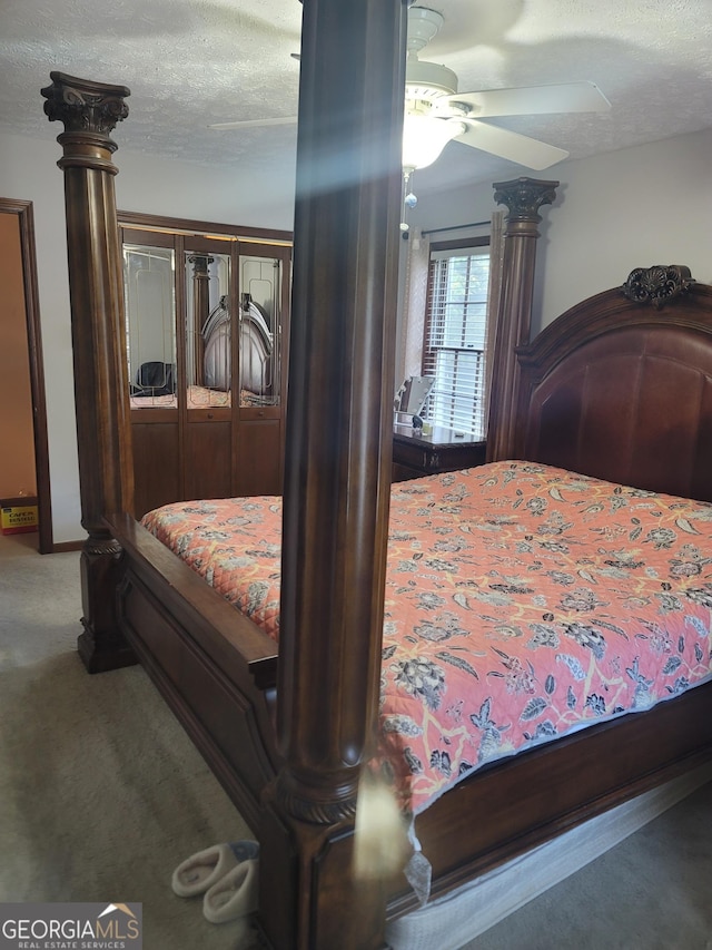 bedroom featuring ceiling fan, a closet, carpet, and a textured ceiling