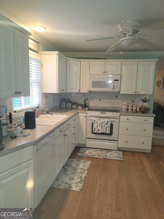 kitchen featuring light hardwood / wood-style flooring, white cabinets, white appliances, and sink