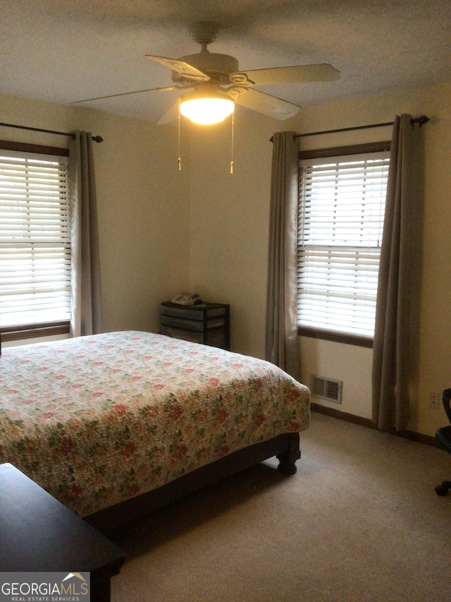 carpeted bedroom with ceiling fan